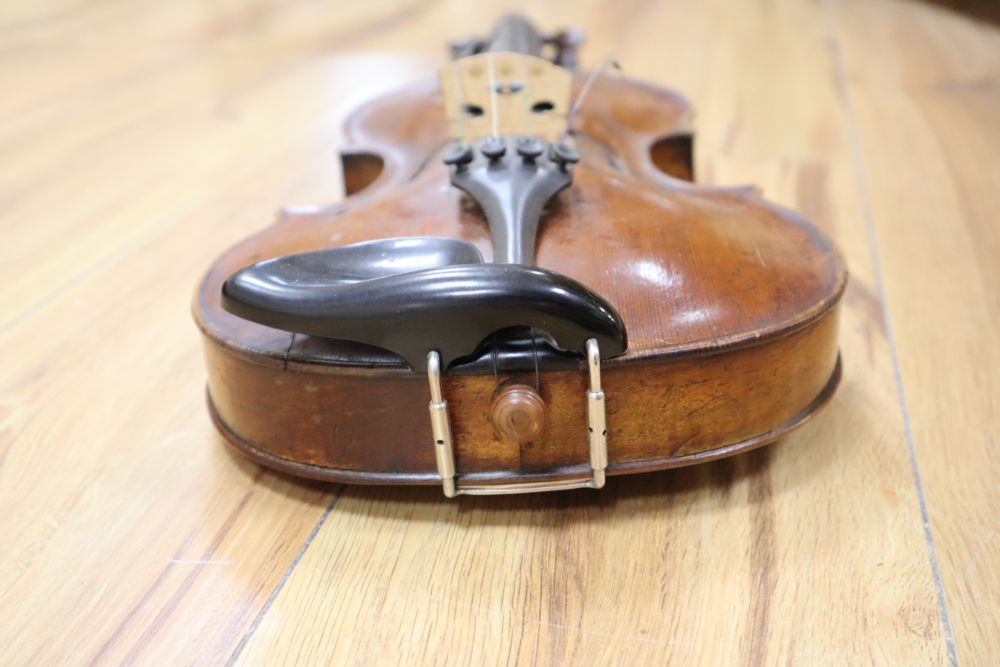 A cased violin with two bows. Violin bears the label Carl Willhelm Claesel, circa late 18th century/early 19th century, 35.5cm back in